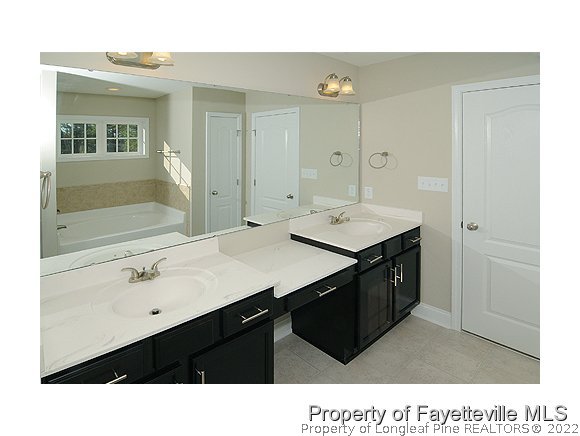 158 Shellbark Drive Spring Lake, NC 28390 - Photo 8 of 15 a bathroom with a sink vanity and a mirror