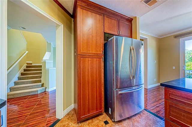 a kitchen with stainless steel appliances granite countertop a refrigerator and a sink