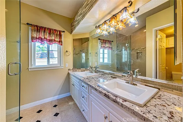 a bathroom with a sink double vanity and a shower