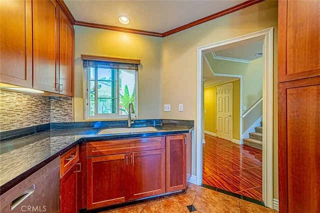 a kitchen with granite countertop a sink and cabinets