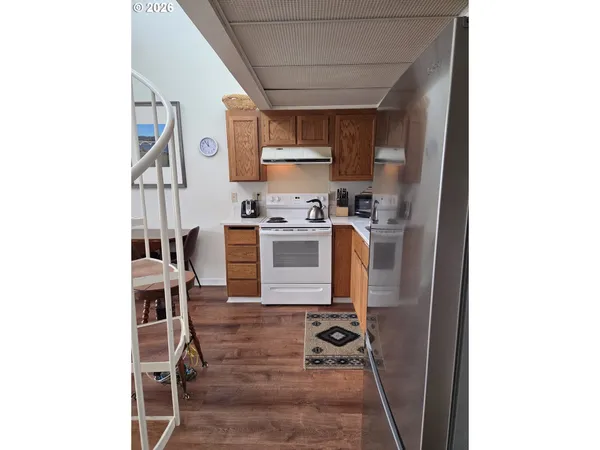 a kitchen with stainless steel appliances granite countertop a stove and a refrigerator