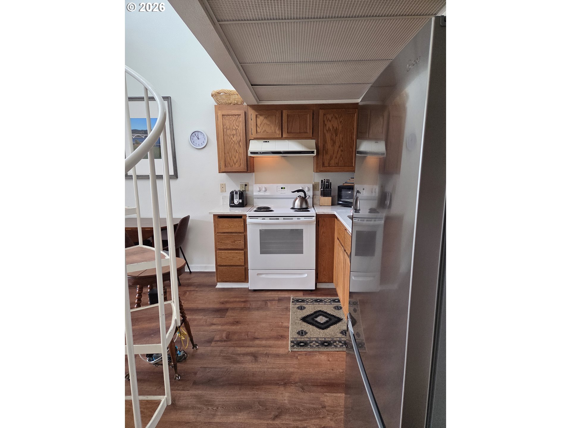 94304 Wedderburn Loop, Unit 437 Gold Beach, OR 97444 - Photo 11 of 20 a kitchen with stainless steel appliances granite countertop a stove and a refrigerator