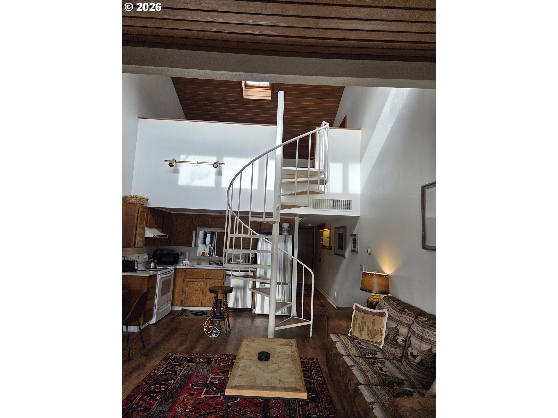 94304 Wedderburn Loop, Unit 437 Gold Beach, OR 97444 - Photo 14 of 20 a room with furniture and a fireplace