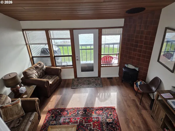 a living room with furniture and a floor to ceiling window