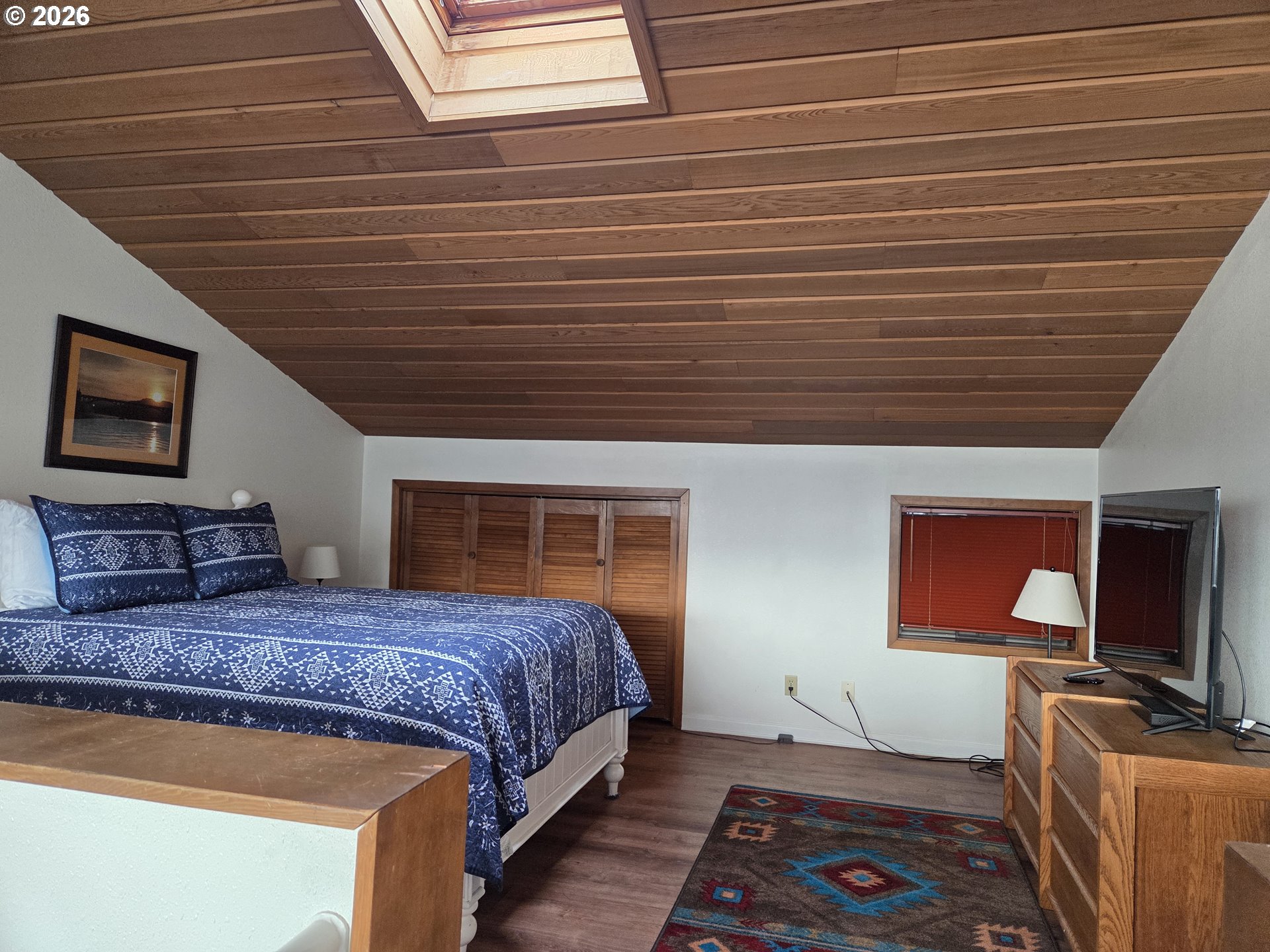 94304 Wedderburn Loop, Unit 437 Gold Beach, OR 97444 - Photo 16 of 20 a bedroom with a bed next to a window