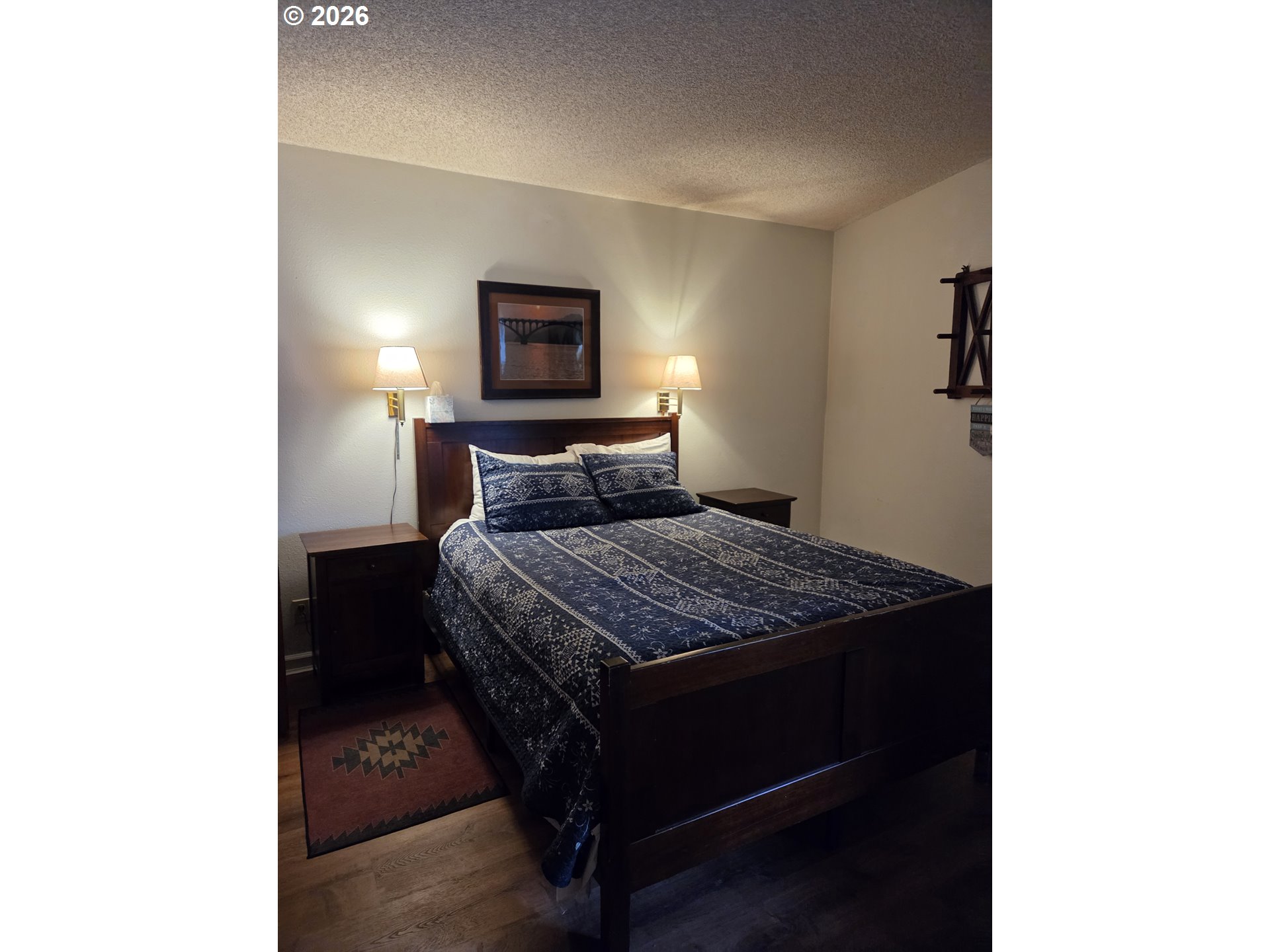 94304 Wedderburn Loop, Unit 437 Gold Beach, OR 97444 - Photo 3 of 20 a bedroom with a bed and a tv