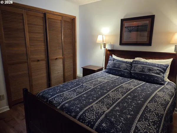 a bedroom with a bed and a painting on the wall