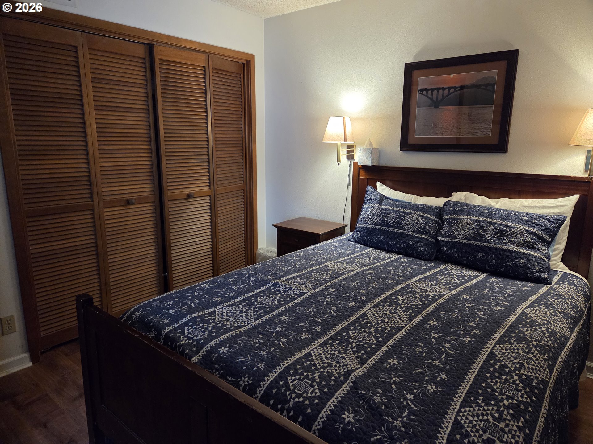 94304 Wedderburn Loop, Unit 437 Gold Beach, OR 97444 - Photo 4 of 20 a bedroom with a bed and a painting on the wall