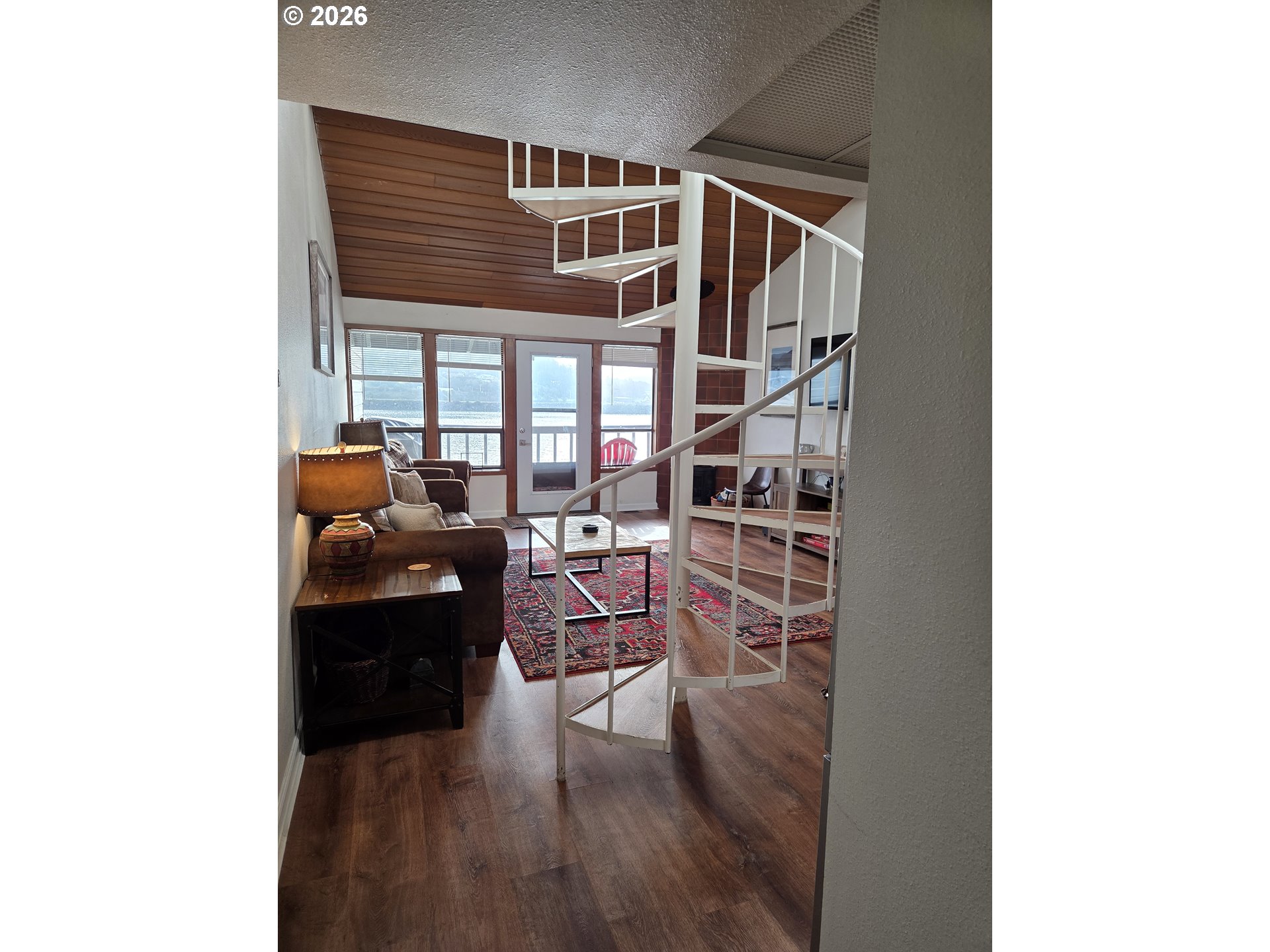 94304 Wedderburn Loop, Unit 437 Gold Beach, OR 97444 - Photo 10 of 20 a living room with furniture and a floor to ceiling window