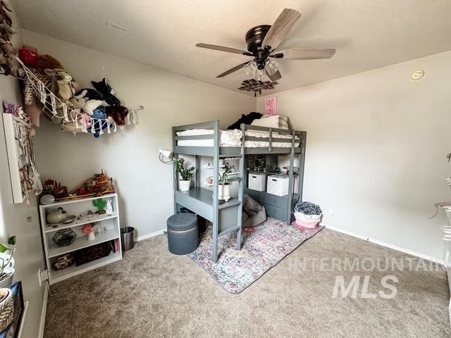 808 O'Leary Way Twin Falls, ID 83301 - Photo 25 of 37 Carpeted room with a ceiling fan light fixture and a built-in bunk bed with integrated desk and shelving