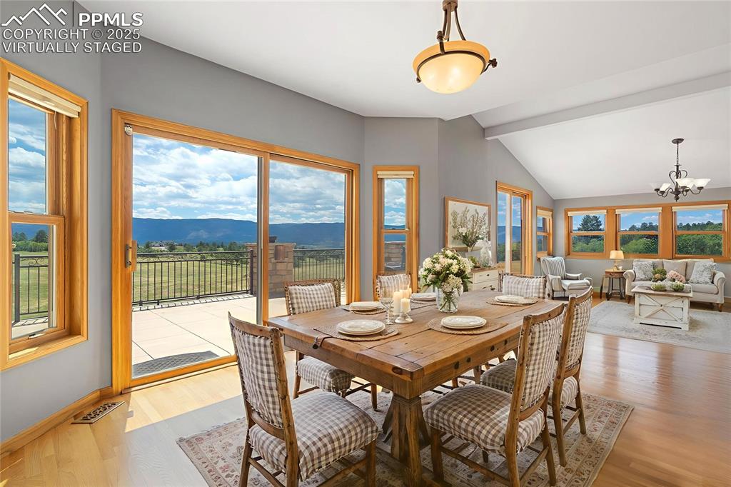 1680 Elk View Road Larkspur, CO 80118 - Photo 14 of 50 a view of a dining room with furniture window and outside view