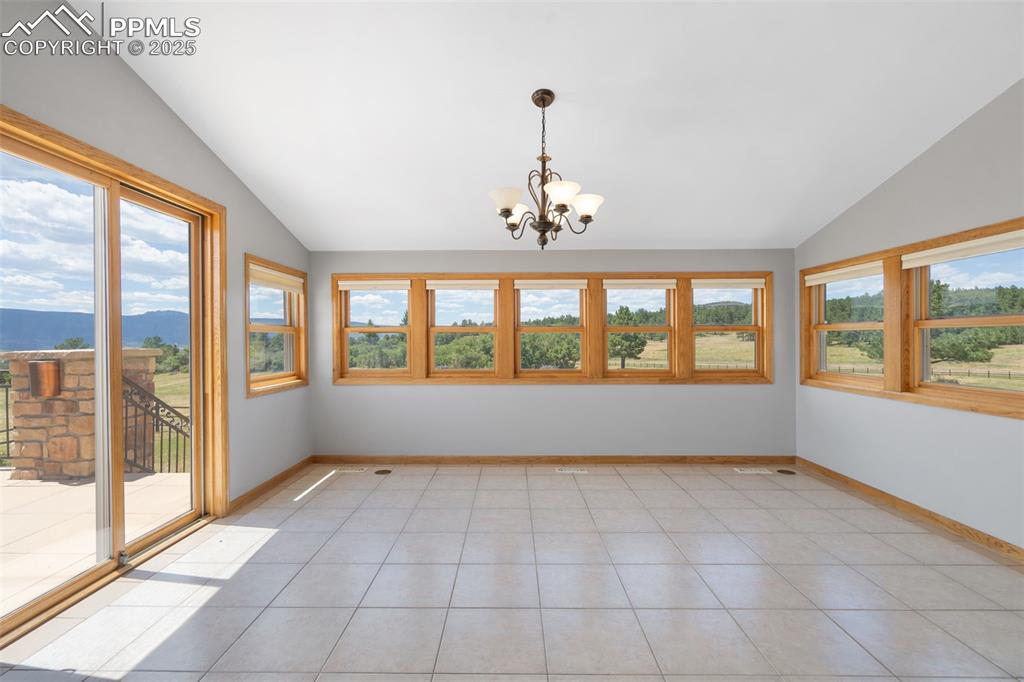 1680 Elk View Road Larkspur, CO 80118 - Photo 15 of 50 a view of an empty room with a window