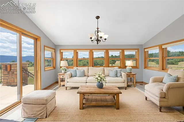 a living room with furniture and large windows