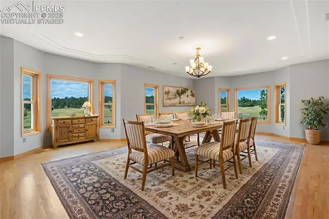 a view of a dining room with furniture window and wooden floor
