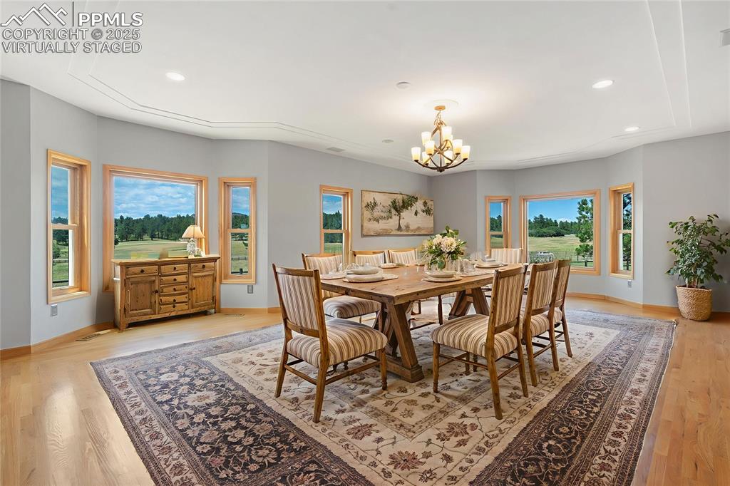 1680 Elk View Road Larkspur, CO 80118 - Photo 17 of 50 a view of a dining room with furniture window and wooden floor