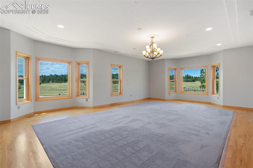 1680 Elk View Road Larkspur, CO 80118 - Photo 18 of 50 a view of an empty room with a window