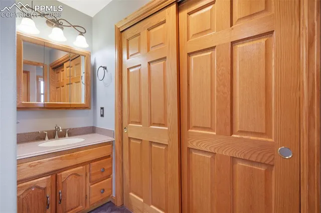 a bathroom with a sink a vanity and a mirror