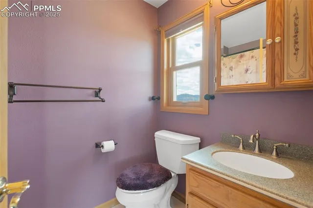 a bathroom with a toilet a sink and a window