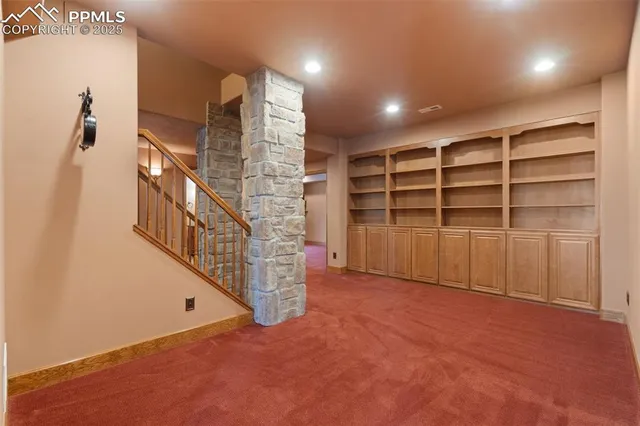 a view of an empty room with a staircase