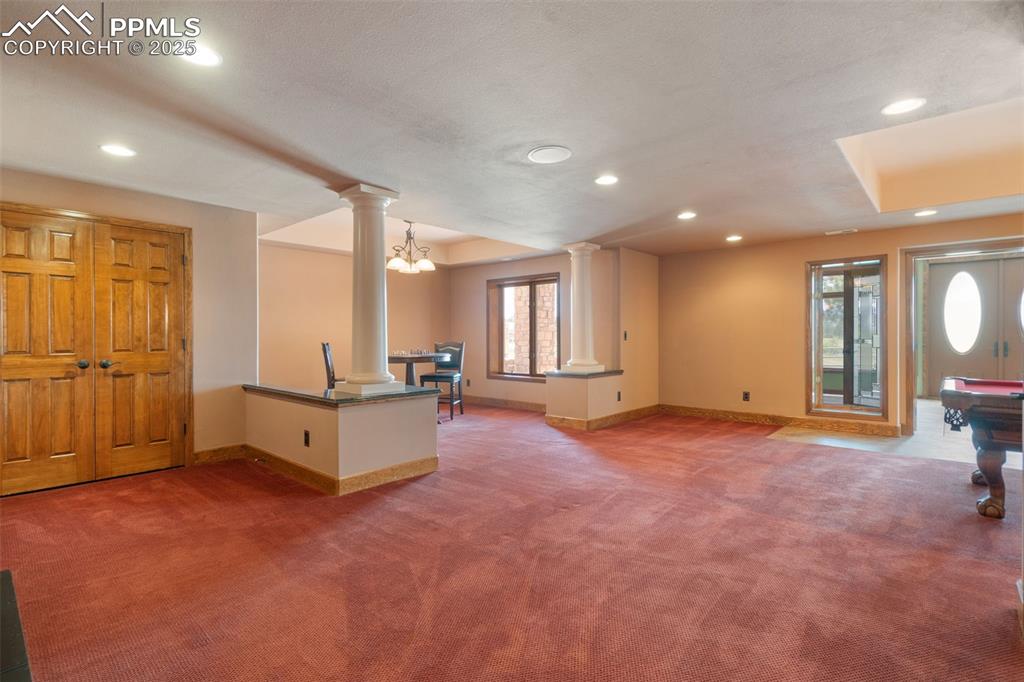 1680 Elk View Road Larkspur, CO 80118 - Photo 33 of 50 a view of an empty room with window and cabinet