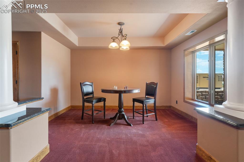 1680 Elk View Road Larkspur, CO 80118 - Photo 34 of 50 a view of a livingroom with furniture window and wooden floor