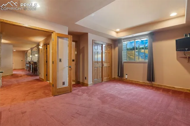 an empty room with windows and closet