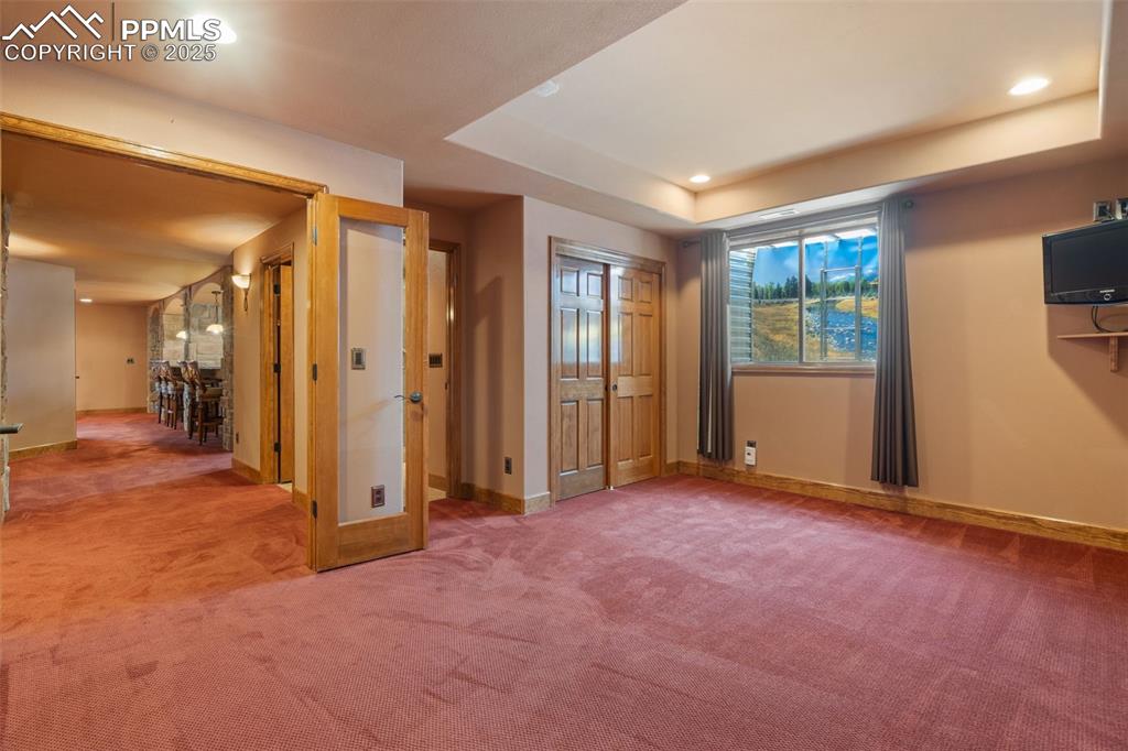 1680 Elk View Road Larkspur, CO 80118 - Photo 37 of 50 an empty room with windows and closet