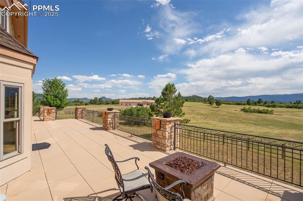 1680 Elk View Road Larkspur, CO 80118 - Photo 39 of 50 a view of a terrace with wooden floor and city view