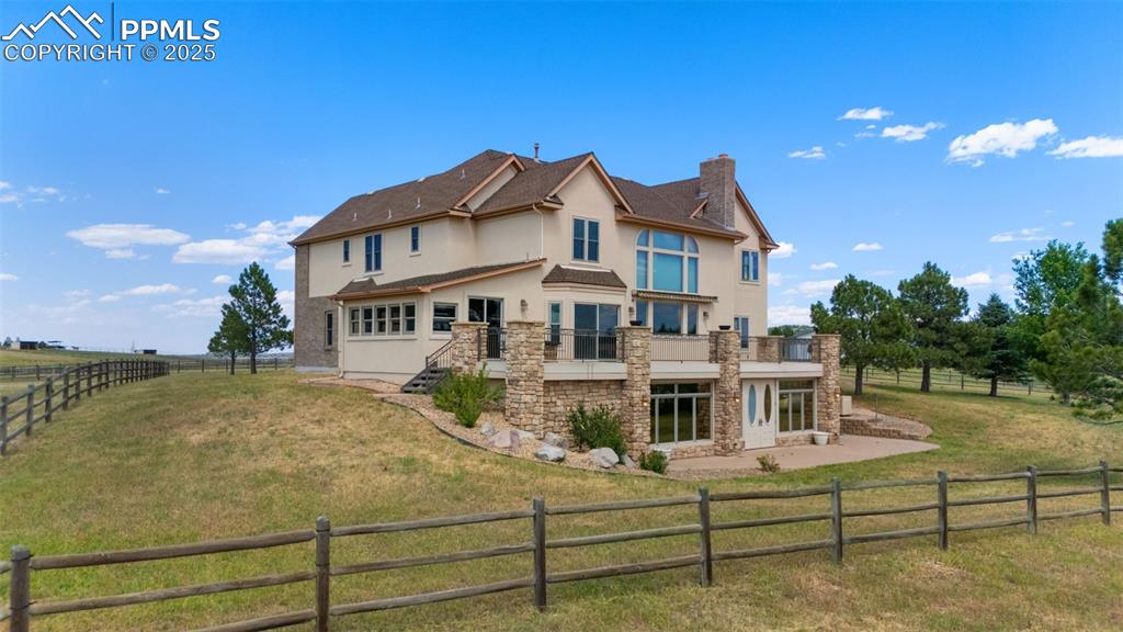 1680 Elk View Road Larkspur, CO 80118 - Photo 40 of 50 a view of a house with a yard