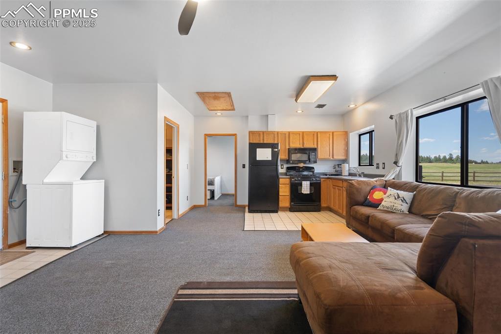 1680 Elk View Road Larkspur, CO 80118 - Photo 47 of 50 a living room with furniture and a large window
