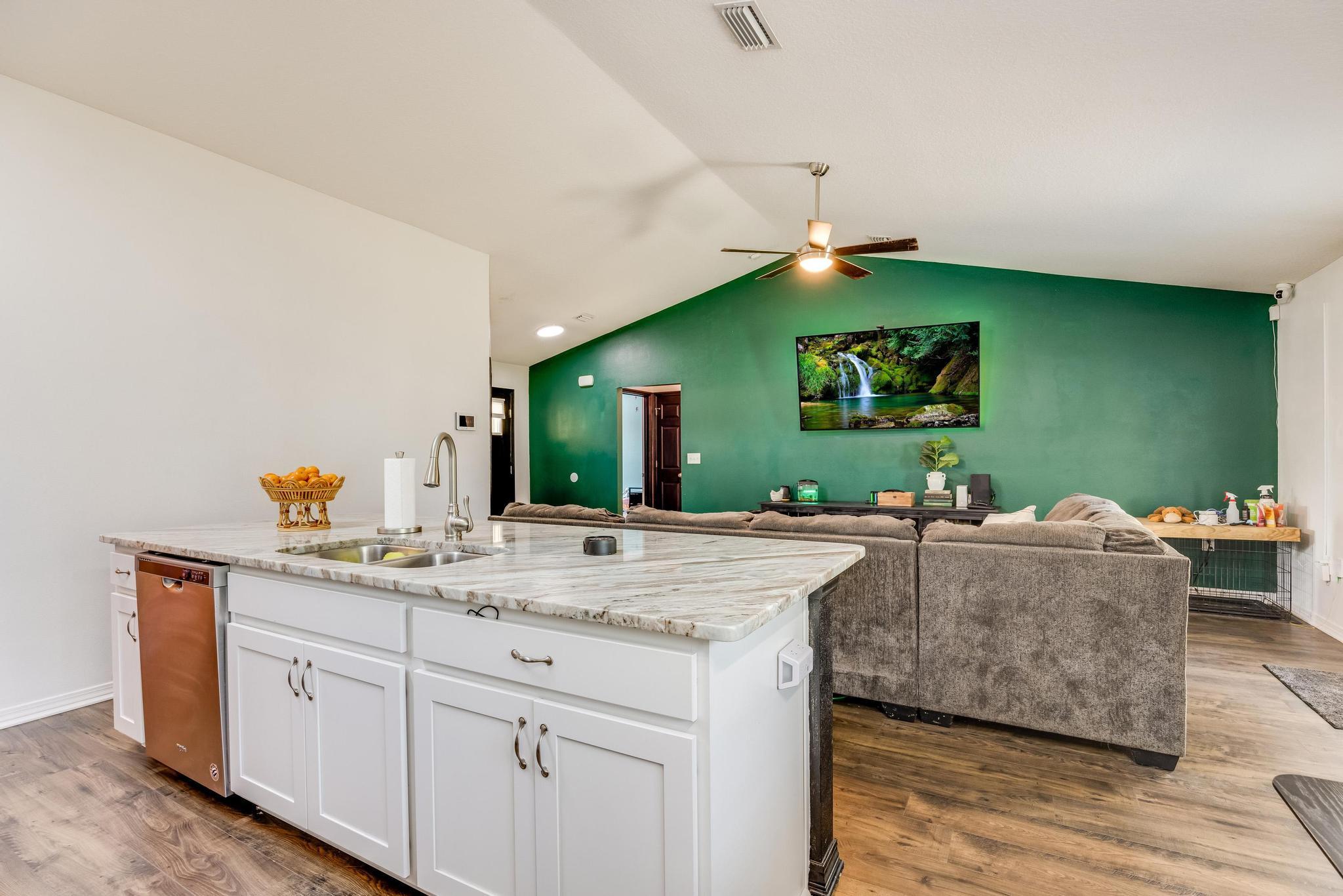 3381 Auburn Road Crestview, FL 32539 - Photo 11 of 46 a living room with kitchen island furniture and a wooden floor