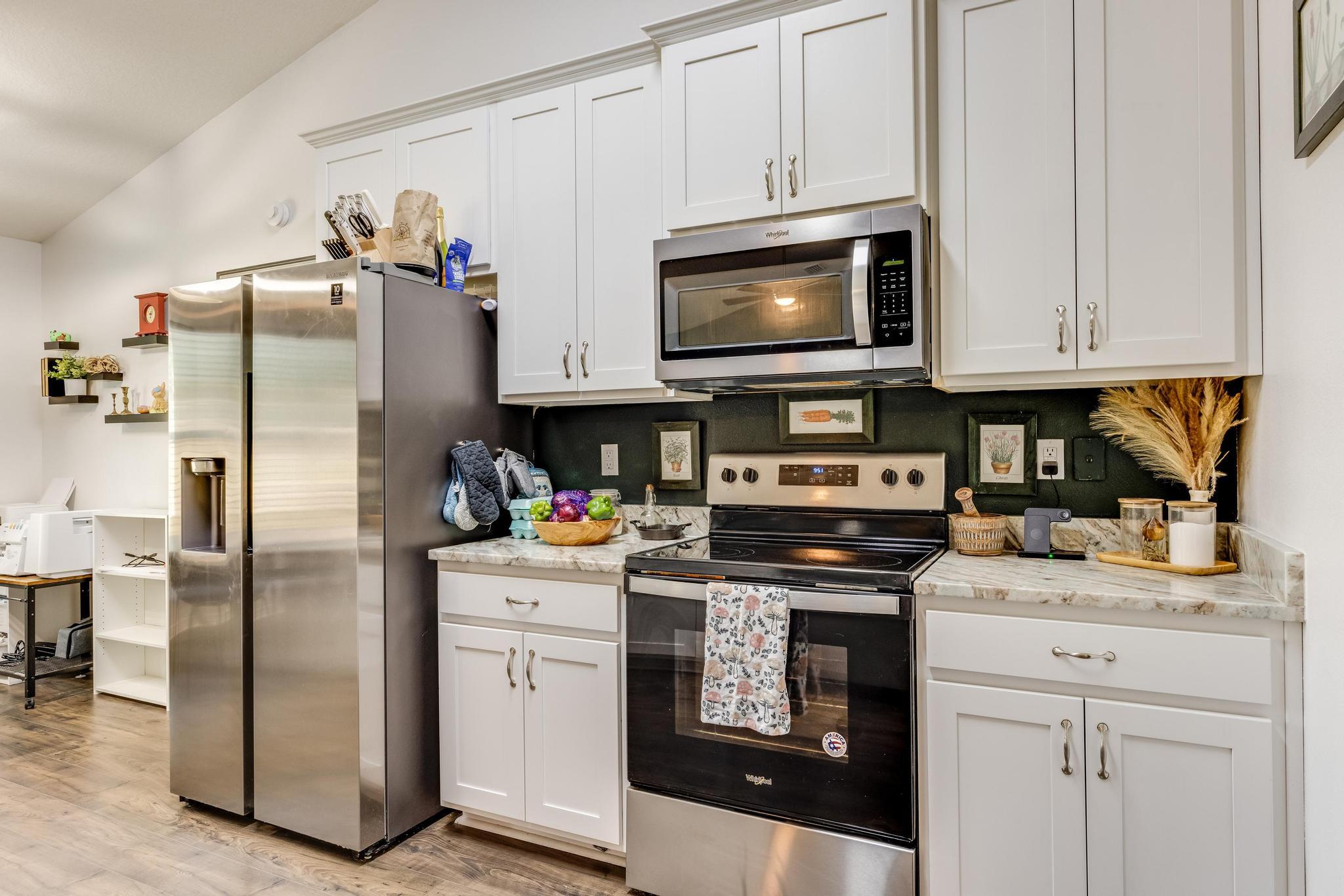 3381 Auburn Road Crestview, FL 32539 - Photo 13 of 46 a kitchen with white cabinets and stainless steel appliances