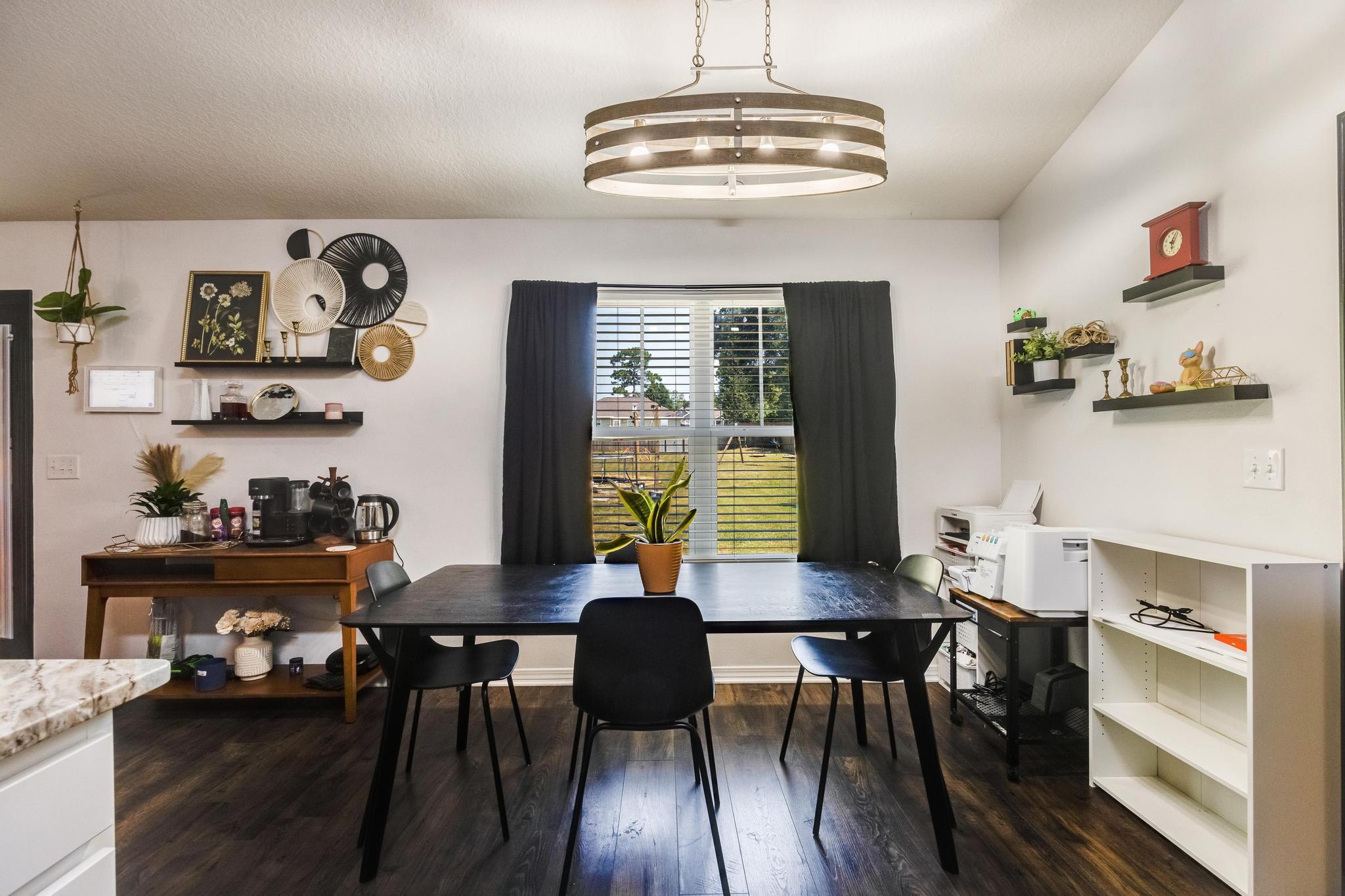 3381 Auburn Road Crestview, FL 32539 - Photo 15 of 46 a view of a dining room with furniture a chandelier and wooden floor