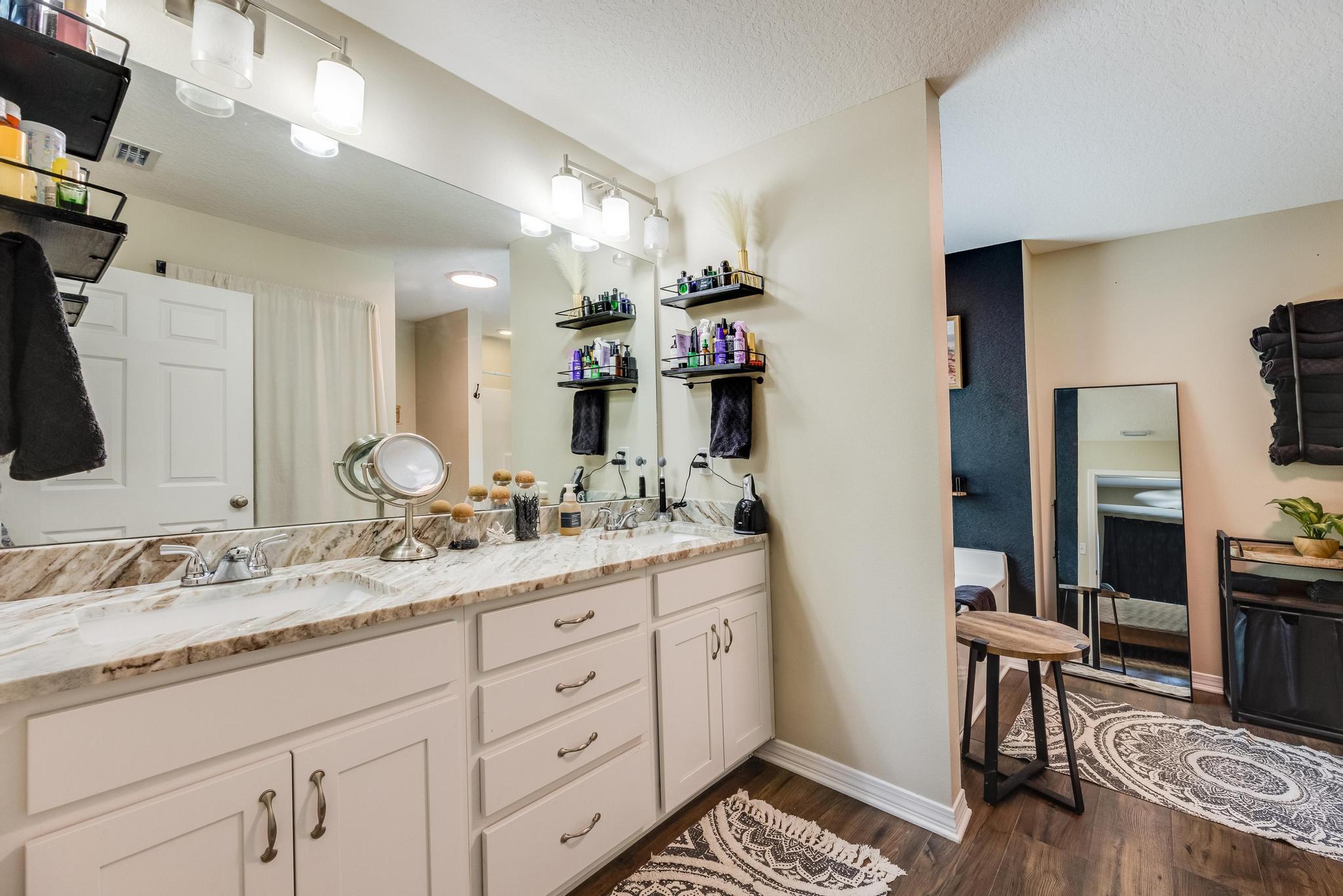 3381 Auburn Road Crestview, FL 32539 - Photo 20 of 46 a bathroom with a sink double vanity granite and a shower