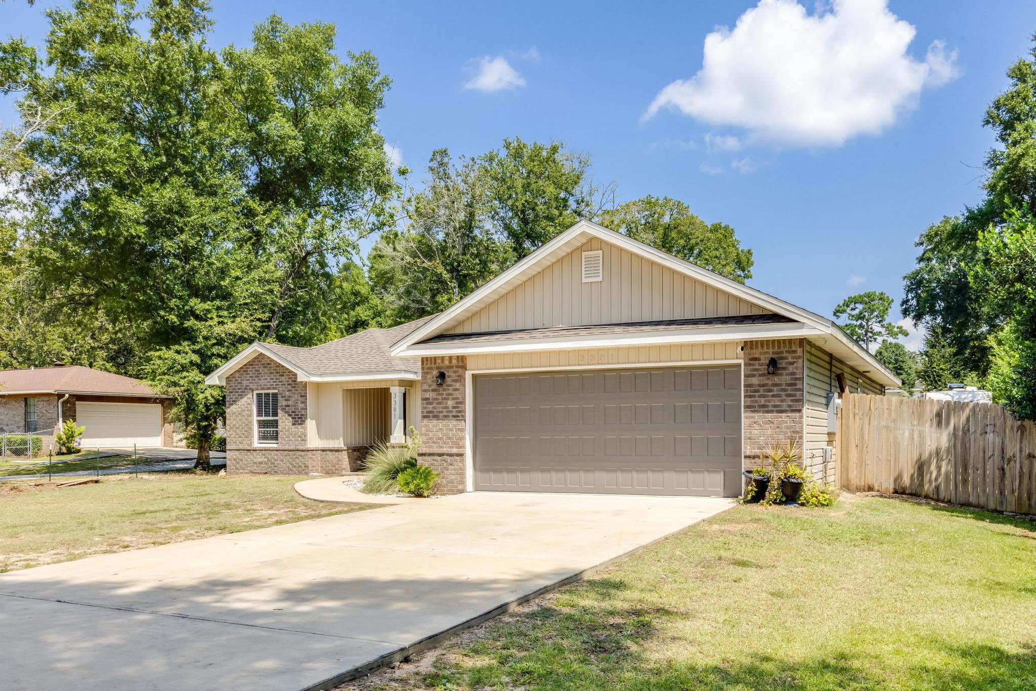 3381 Auburn Road Crestview, FL 32539 - Photo 2 of 46 a front view of a house with a yard and garage
