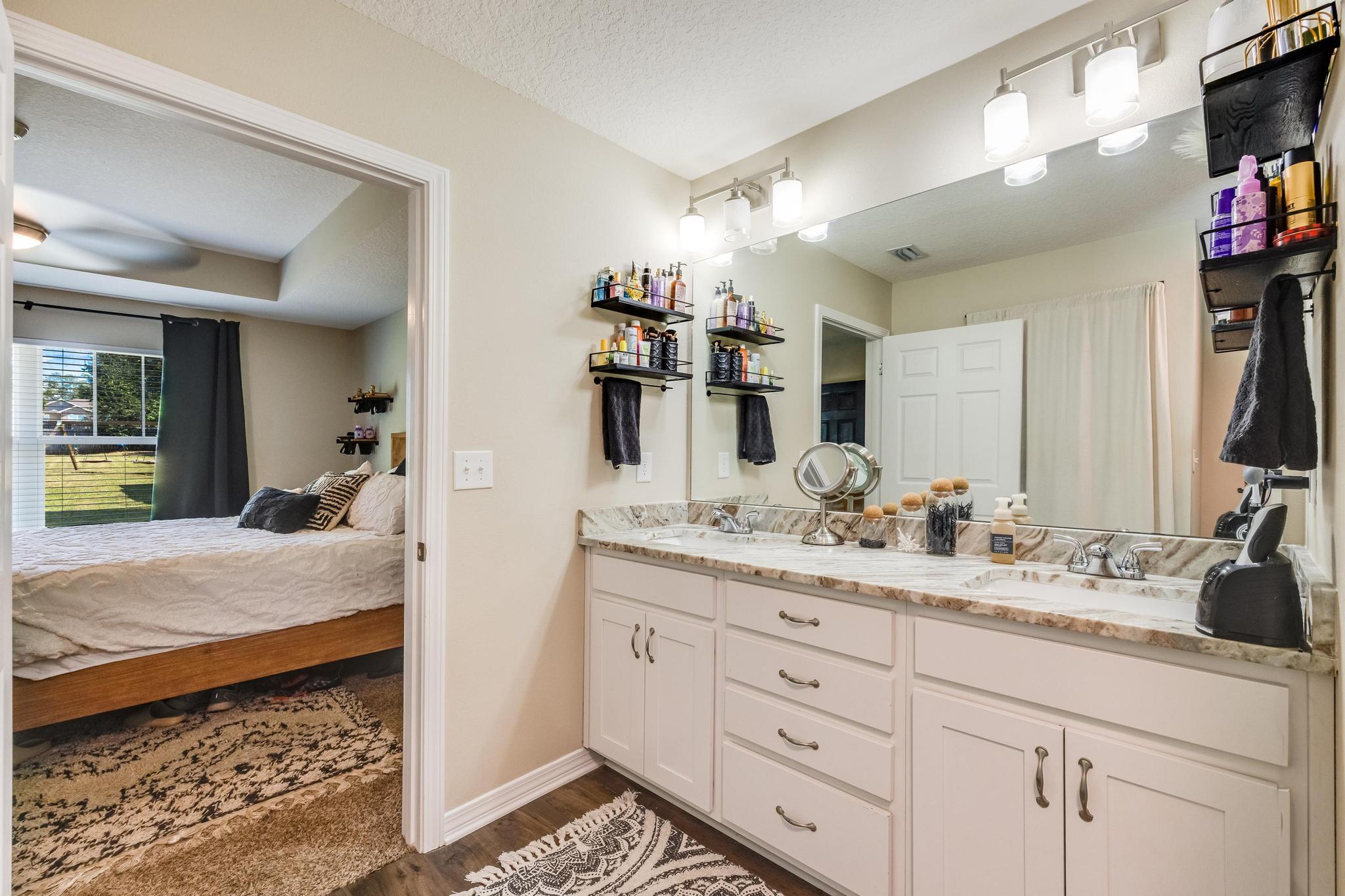 3381 Auburn Road Crestview, FL 32539 - Photo 21 of 46 a en suite bathroom with double sink and a mirror