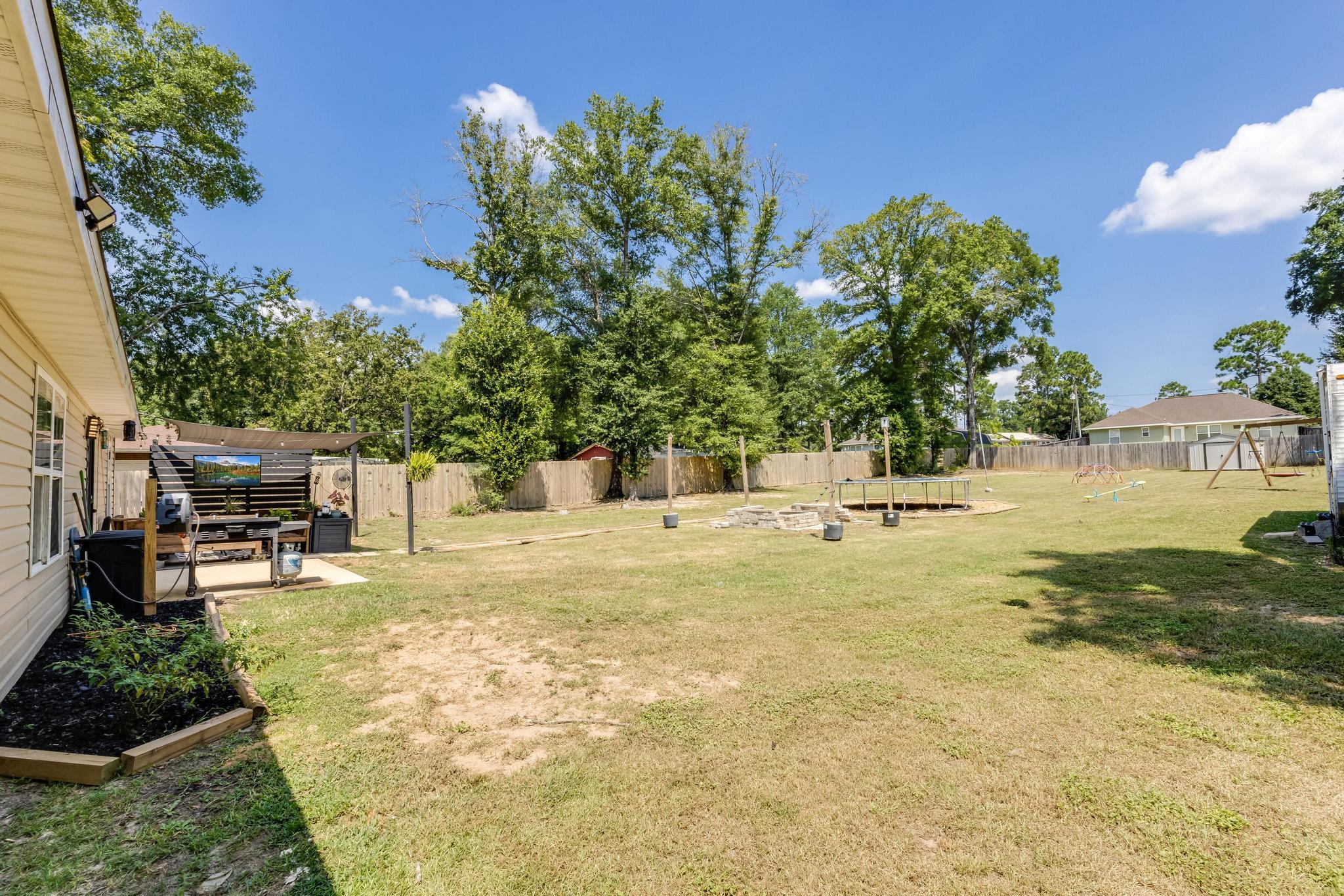 3381 Auburn Road Crestview, FL 32539 - Photo 37 of 46 a view of a yard with swimming pool
