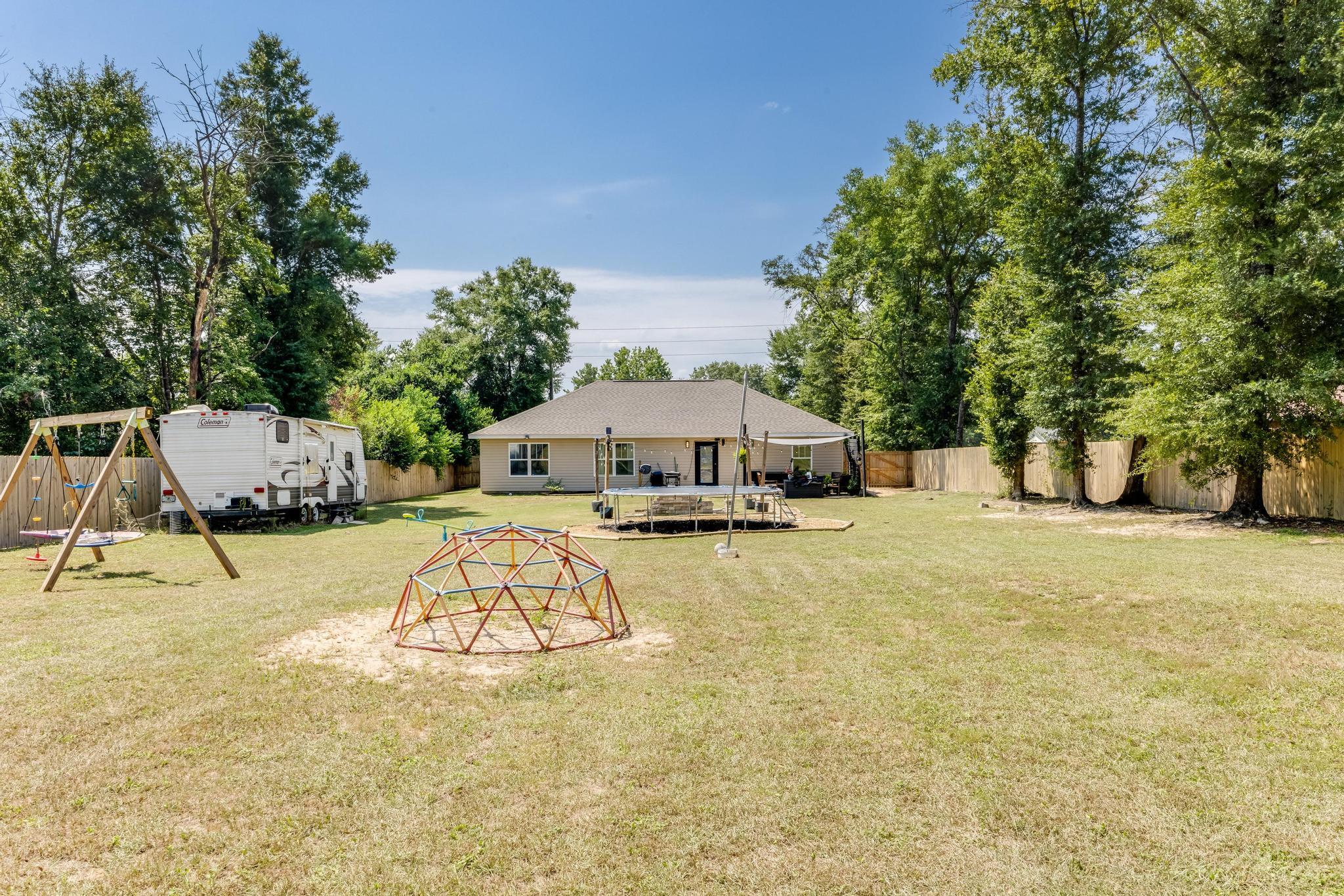 3381 Auburn Road Crestview, FL 32539 - Photo 38 of 46 a swimming pool with a yard and seating area
