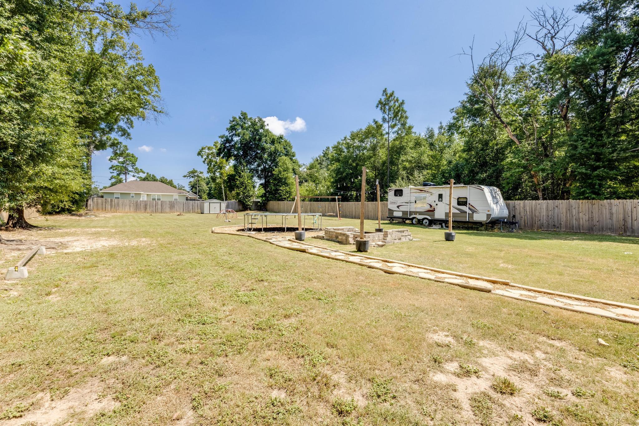 3381 Auburn Road Crestview, FL 32539 - Photo 39 of 46 a view of a swimming pool with an outdoor space and seating area