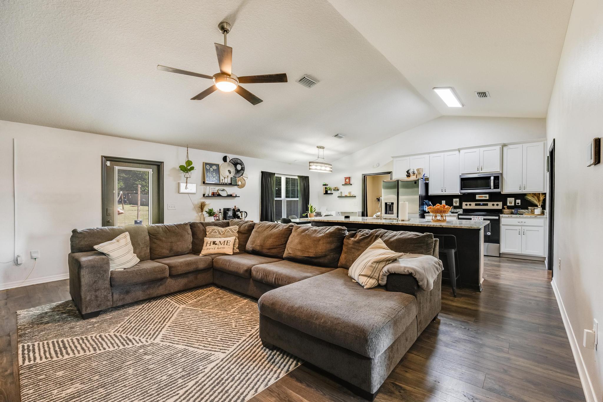 3381 Auburn Road Crestview, FL 32539 - Photo 5 of 46 a living room with furniture kitchen view and a chandelier