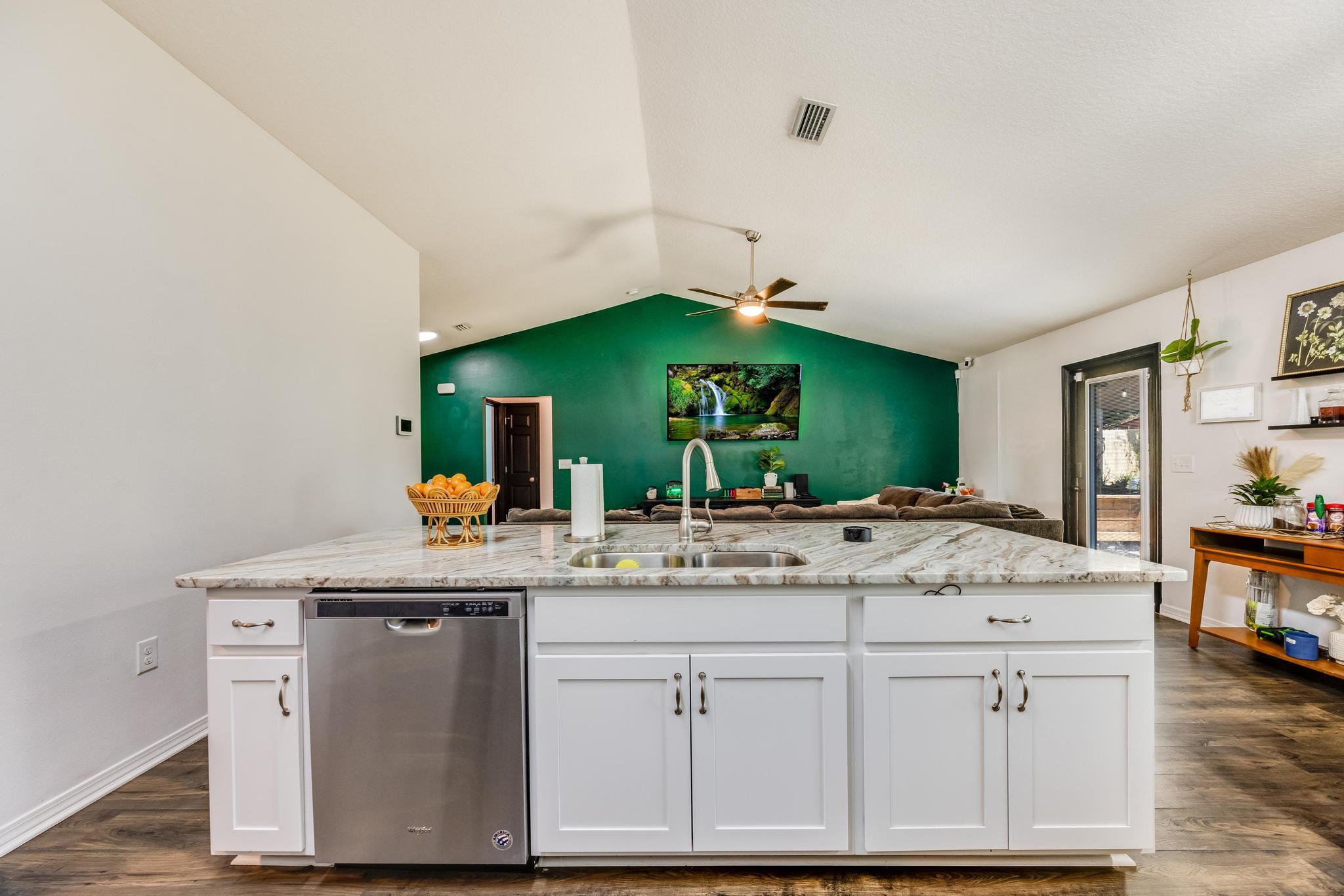 3381 Auburn Road Crestview, FL 32539 - Photo 10 of 46 a room with kitchen island a sink and wooden floor