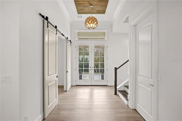a view of kitchen with refrigerator and window