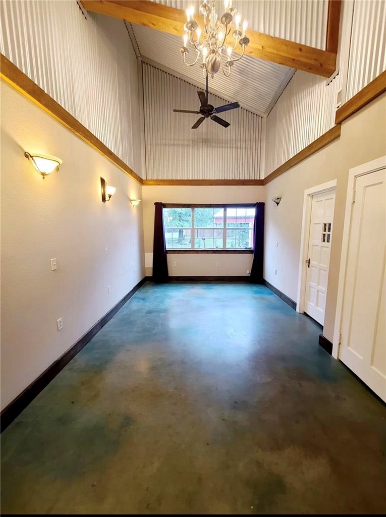 5325 County Road 2291 Centerville, TX 75833 - Photo 11 of 31 Room featuring suspended lighting, lofted ceiling, ceiling fan, and concrete floors