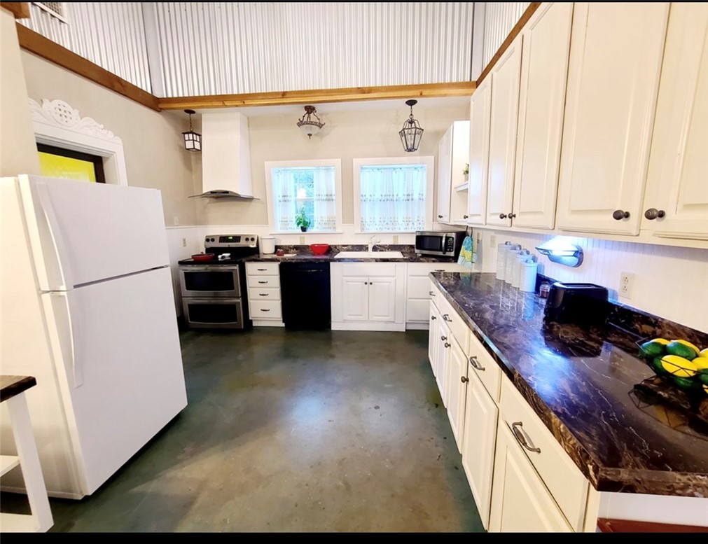 5325 County Road 2291 Centerville, TX 75833 - Photo 2 of 31 Kitchen with appliances, finished concrete flooring, and white cabinetry