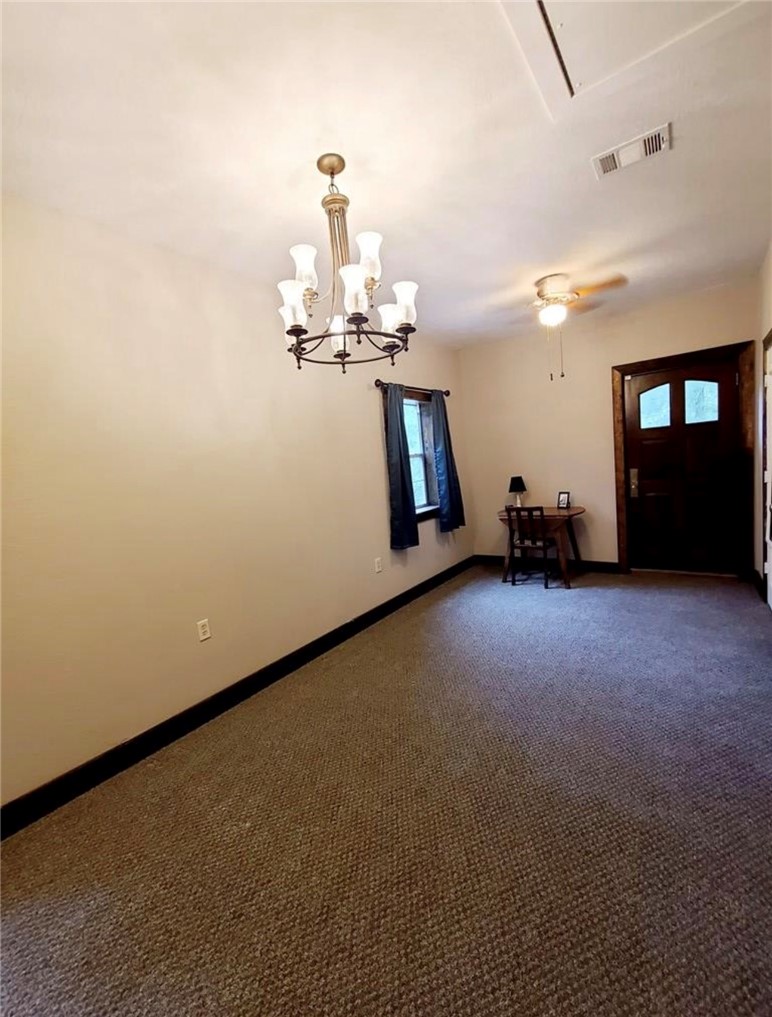 5325 County Road 2291 Centerville, TX 75833 - Photo 28 of 31 Room featuring dark carpet, a ceiling fan, and hanging lights