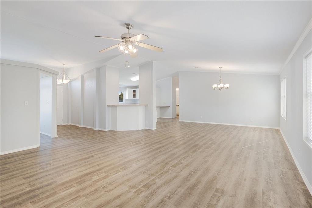 4775 Highway 91 Denison, TX 75020 - Photo 11 of 19 a view of an empty room with wooden floor and a kitchen
