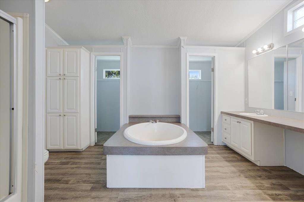 4775 Highway 91 Denison, TX 75020 - Photo 18 of 19 a bathroom with a tub a sink and a mirror