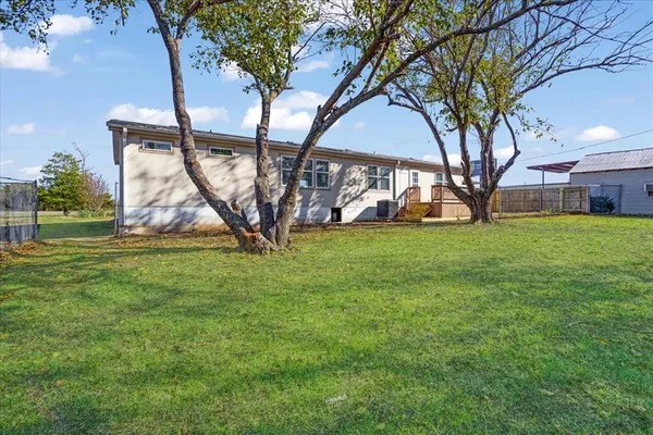 a view of a house with a backyard