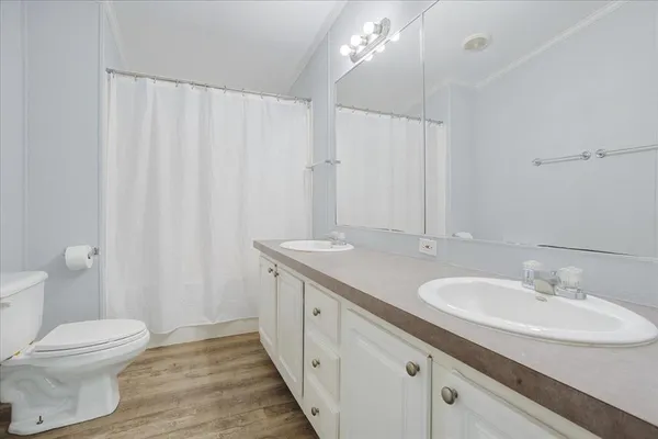 a bathroom with a double vanity sink and a mirror