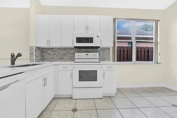 a kitchen with cabinets and appliances